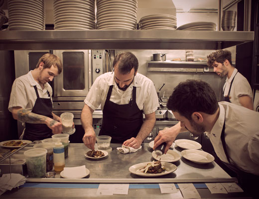 Chefs prepare dishes in Rucola's kitchen