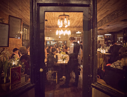 Waiter and diners at Rucola